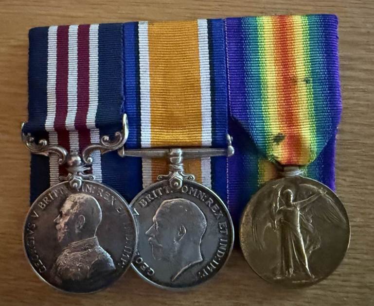 Two medals on a table

Description automatically generated
